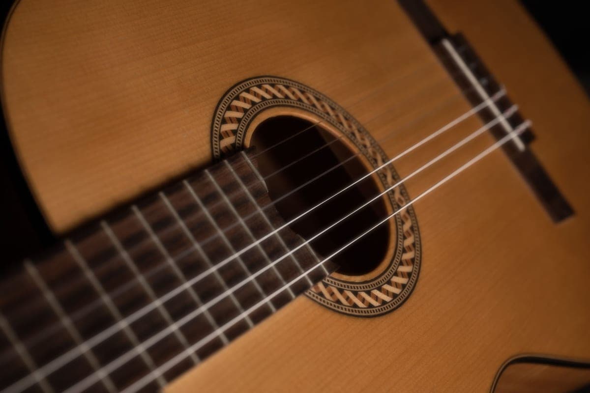 The soundhole and strings of an acoustic guitar in close-up