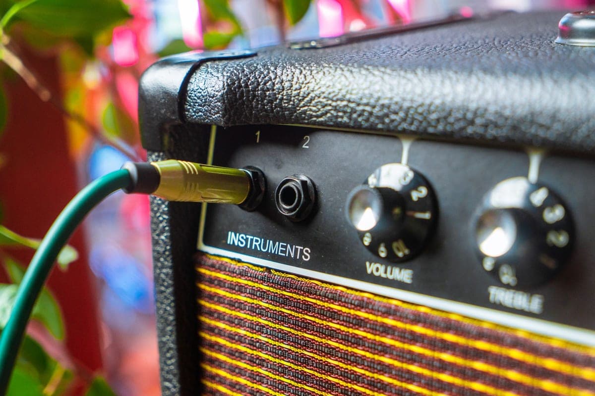 An instrument cable plugged into a guitar amplifier