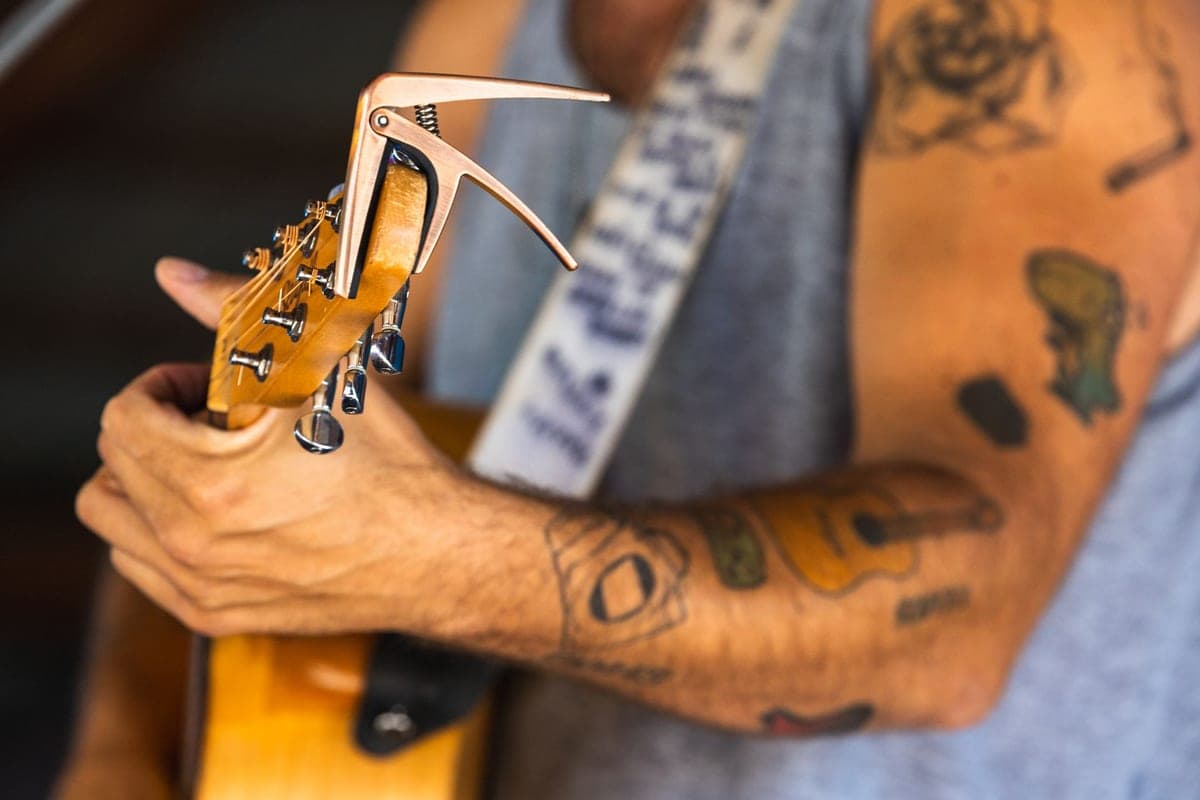 A capo clamped near the nut of a guitar neck