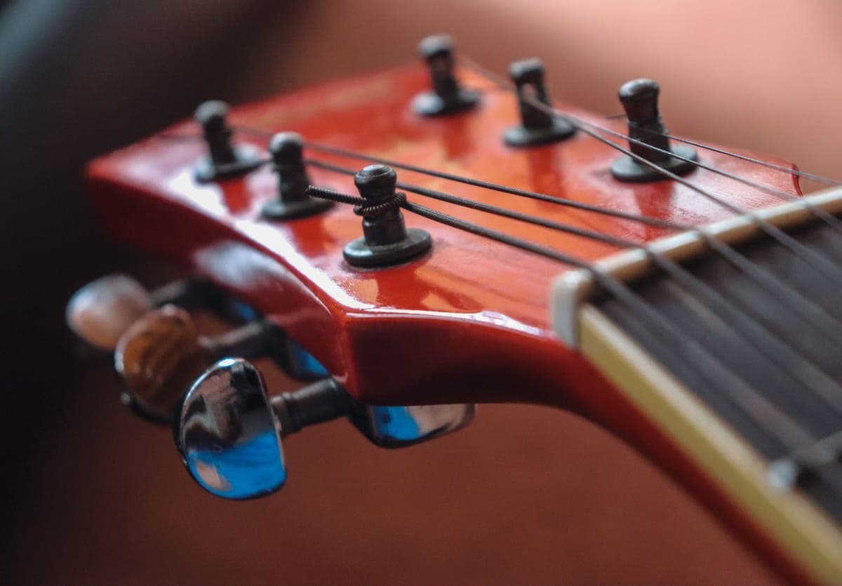 Two sets of acoustic guitar strings, one coated and one plain