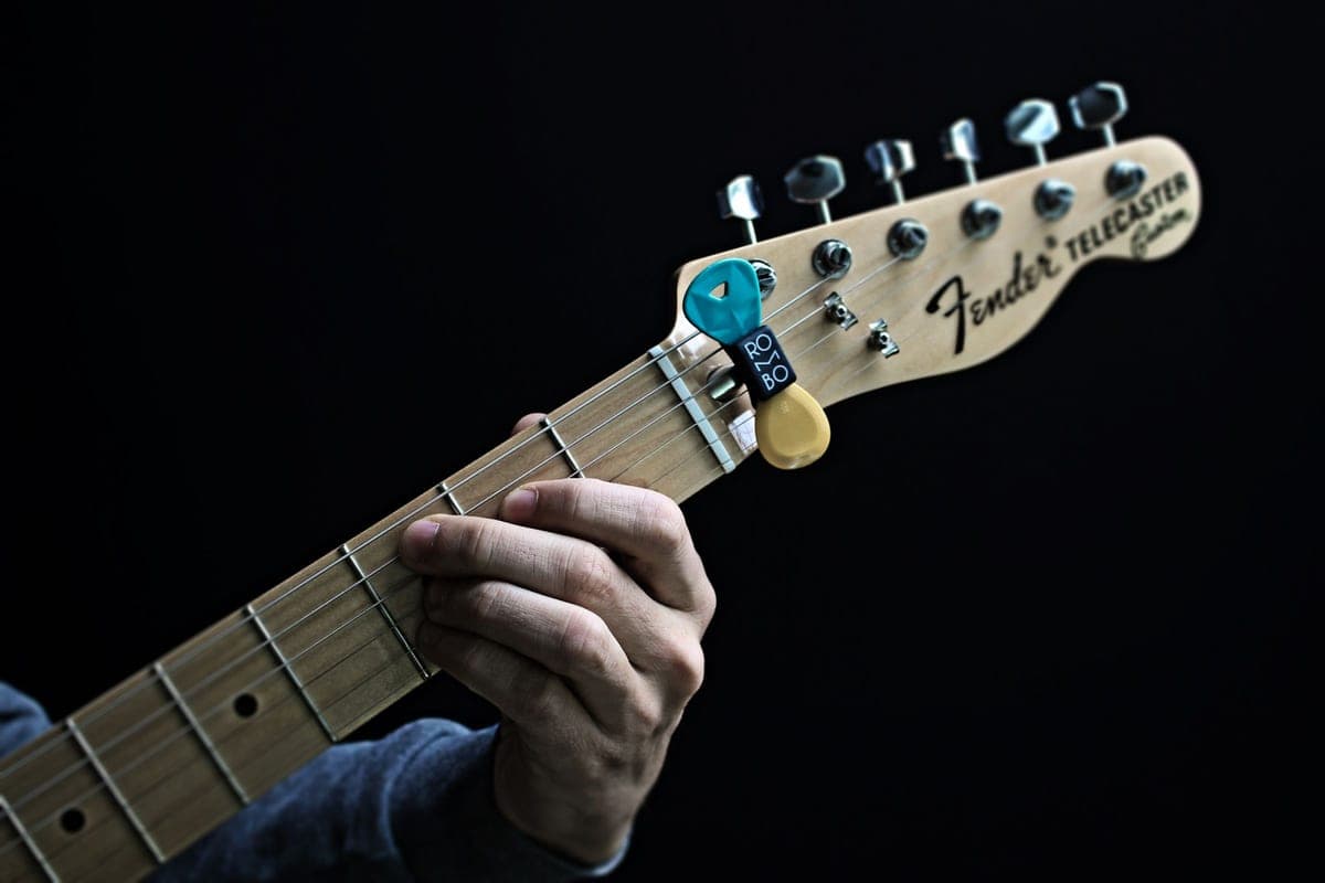 The neck and fretboard of an electric guitar in close-up
