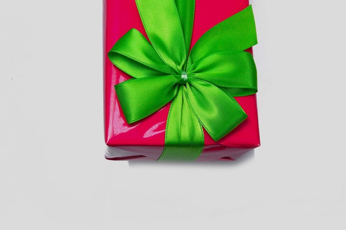 A wrapped gift with a ribbon on a plain background