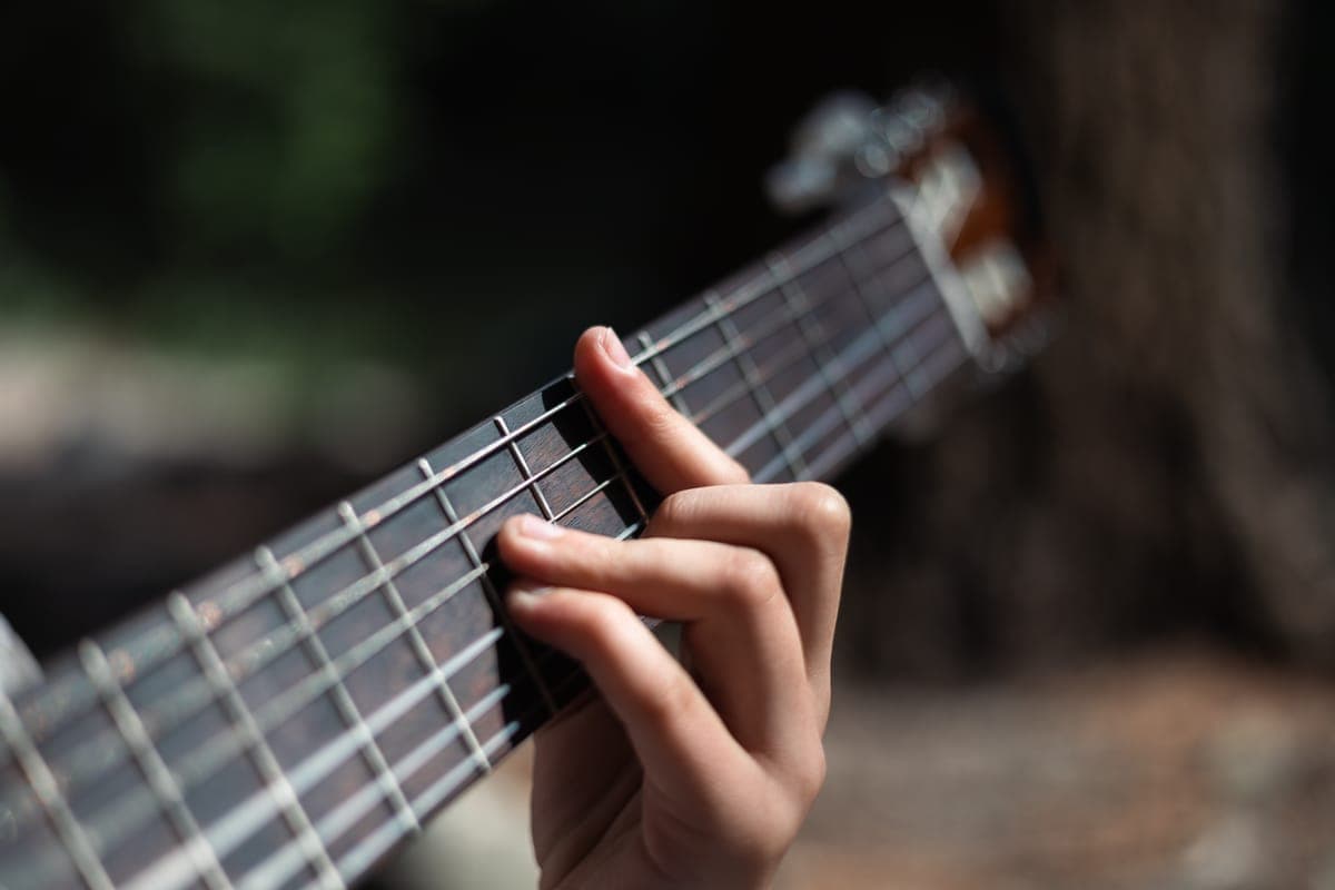 A cloth being used to clean a guitar fretboard