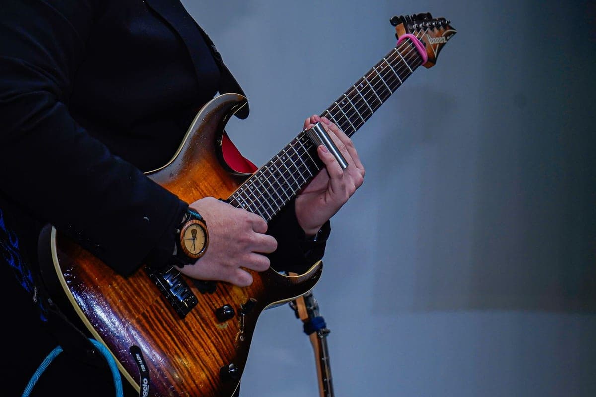 A close-up of a musician playing an electric guitar
