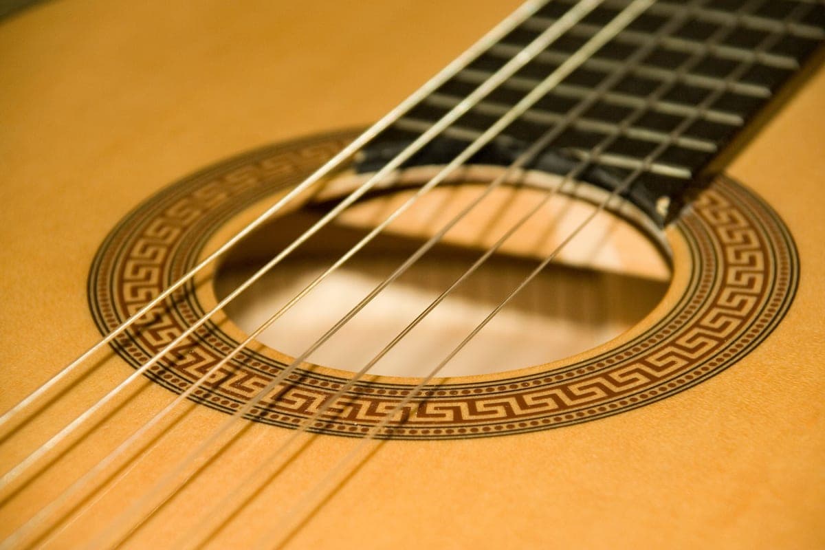 The strings and sound hole of a classical acoustic guitar, close up