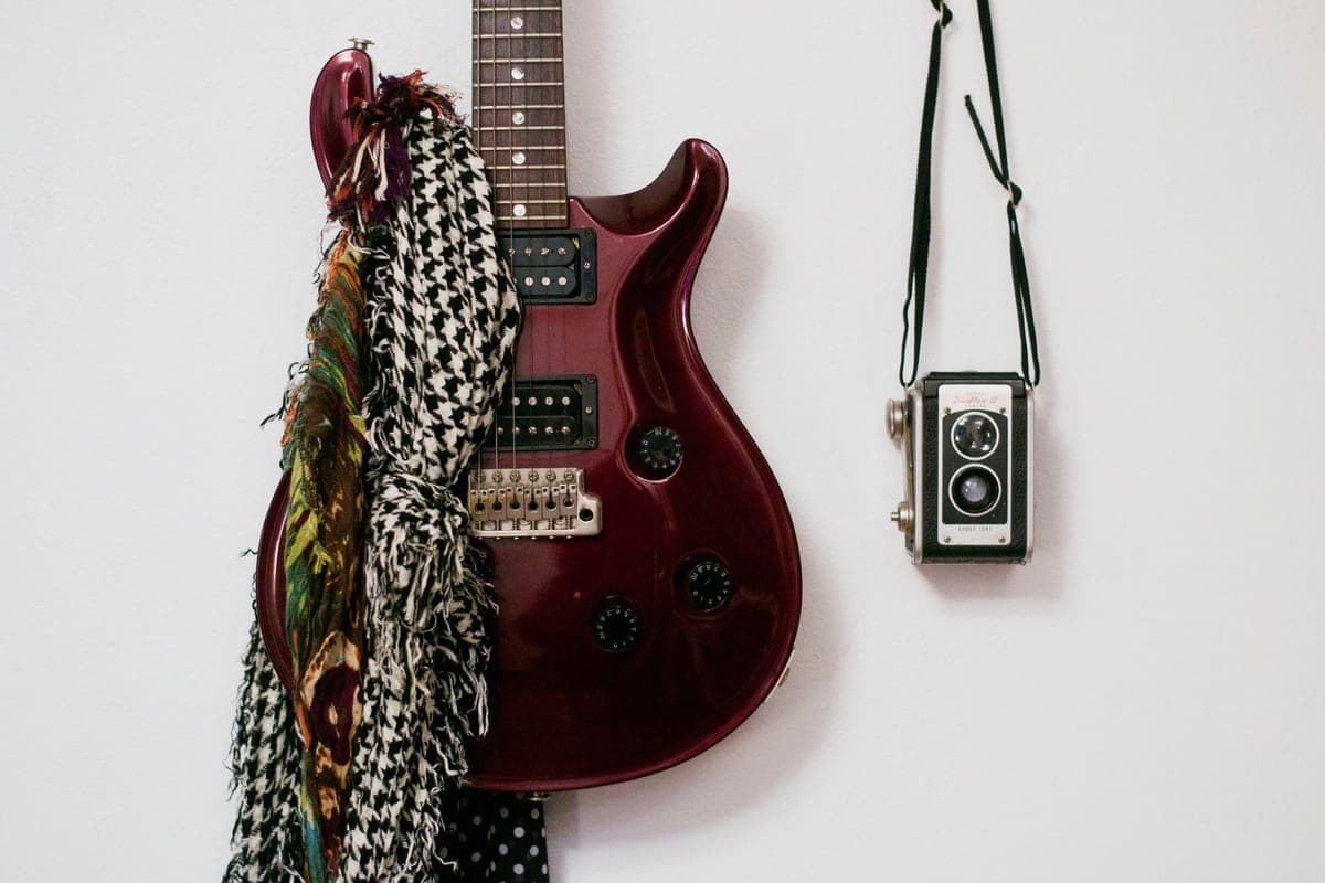 An electric guitar mounted on a plain wall